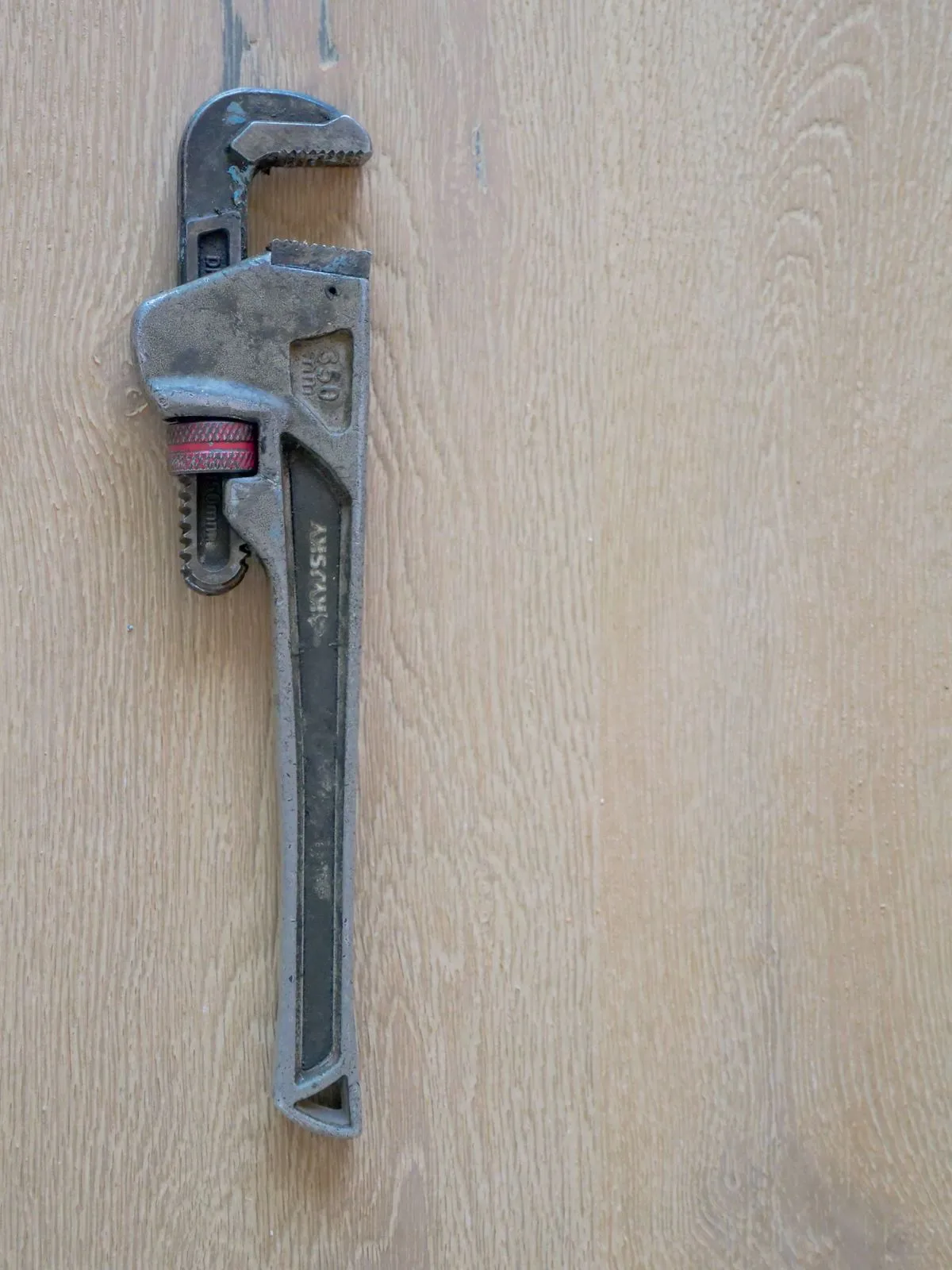 Plumber adjusting a wrench on a residential water supply valve